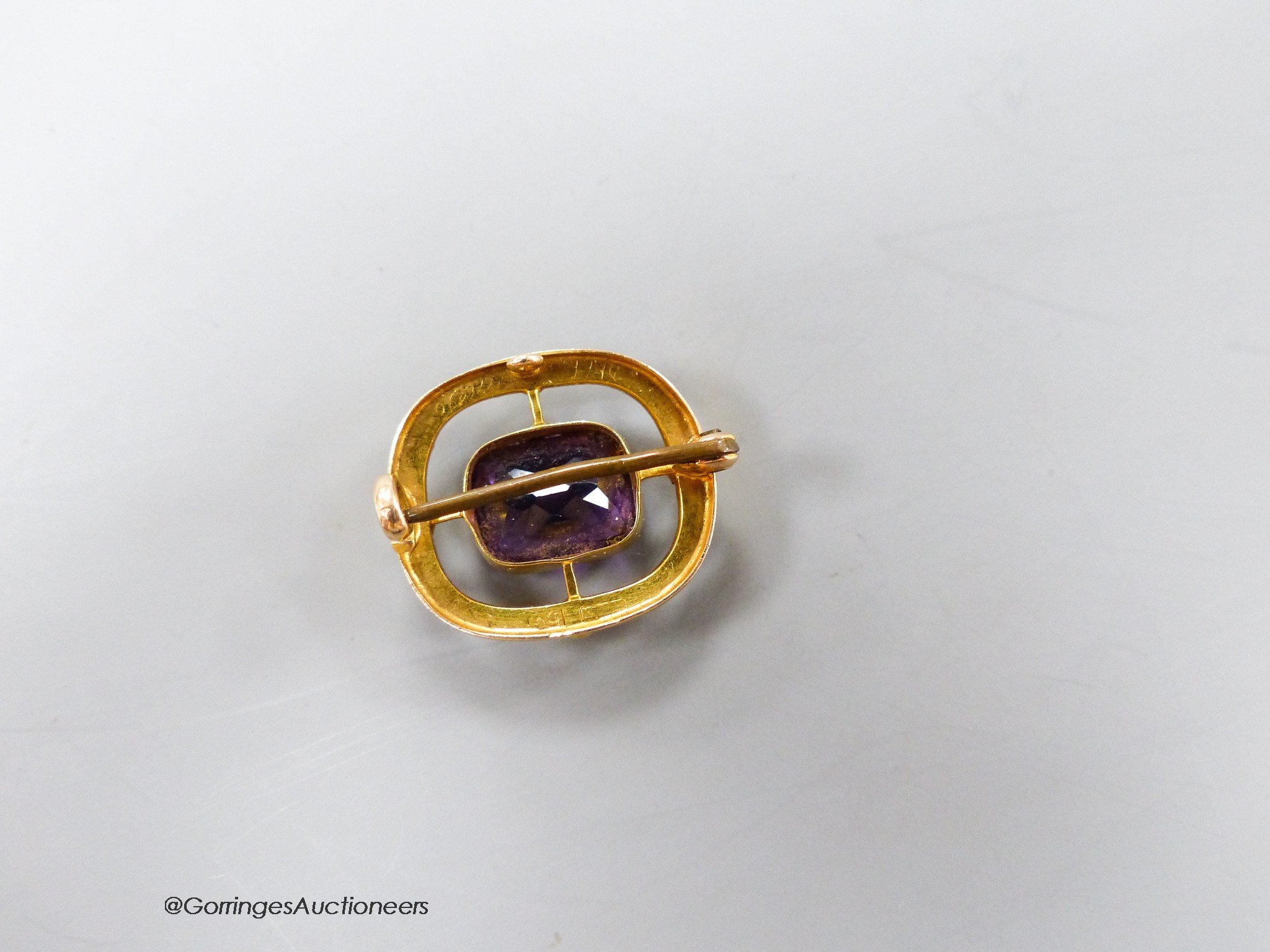 An early 20th century 15ct, amethyst, garnet and seed pearl pendant brooch, in the suffragette colours, 21mm, gross 3.6 grams.